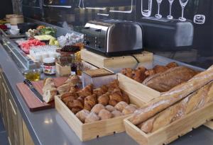 a bakery counter with lots of different types of bread at Campanile Shanghai Huaihai in Shanghai
