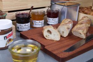 a cutting board with loaves of bread and jars of honey at Campanile Shanghai Huaihai in Shanghai