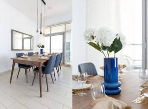 a dining room with a table and a blue vase with white flowers at Frank Porter - Torch Tower in Dubai