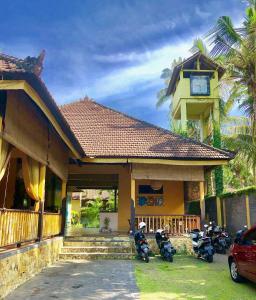 a group of motorcycles parked in front of a house at Arco Iris Boutique Hotel & Restaurant in Candidasa