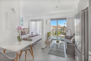 a kitchen and living room with a table and a couch at Elysia Park in Paphos
