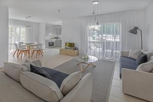 a living room with a couch and a table at Elysia Park in Paphos