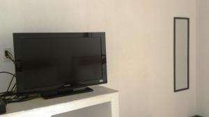 a flat screen tv sitting on top of a table at Hotel Maricarmen in Manzanillo