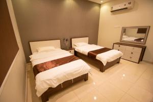 Postel nebo postele na pokoji v ubytování Waha AL Mudaif Serviced Apartments