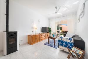 a living room with a couch and a stove at Ca na Rosa (Es Portitxol) in Palma de Mallorca