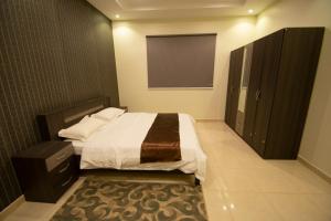Postel nebo postele na pokoji v ubytování Waha AL Mudaif Serviced Apartments