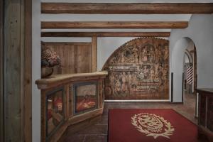 a room with a large wooden wall with a mural at Hotel Goldener Greif in Kitzbühel