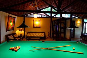 a living room with a pool table with cue balls at Canto d Alvorada Hotel Pousada in Arraial d'Ajuda