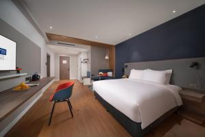Postel nebo postele na pokoji v ubytování Holiday Inn Express Shanghai Huijin by IHG