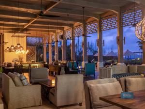 a lobby of a resort with chairs and tables at Selong Selo Resort and Residences in Selong Belanak