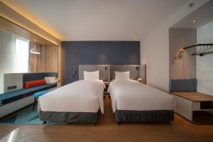 Postel nebo postele na pokoji v ubytování Holiday Inn Express Shanghai Huijin by IHG