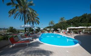 a swimming pool with chairs and umbrellas at THotel Lamezia in Lamezia Terme