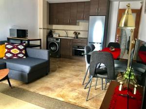 a living room with a couch and a table and a kitchen at SKI & NATURE JAVALAMBRE in Camarena de la Sierra
