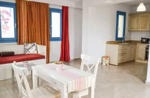 a kitchen and living room with a table and chairs at Finiki Villas in Foinikion
