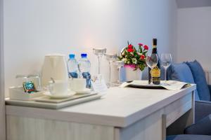 a table topped with a vase filled with flowers at Hotel Jantar Wellness & Spa in Ustka