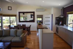a kitchen and living room with a couch and a table at Redgate Beach Escape in Witchcliffe