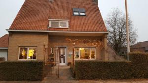 a house with christmas lights on the front of it at B&B Villa Vanilla in Ieper