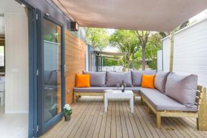 a patio with a couch and a table at Tamarit Beach Resort in Tamarit