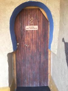 a wooden door with a number on it at Kasbah Luna del Sur in Merzane