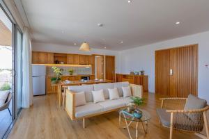 a living room and kitchen with a couch and a table at Prana Boutique Hotel and Apartments in Da Nang