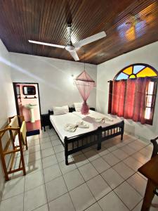 a room with a bed with a table and a window at Casalanka Hotel in Hikkaduwa