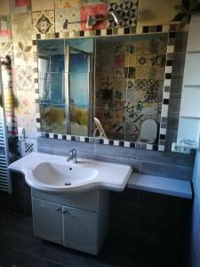 a bathroom with a sink and a mirror at Ferienwohnungen-Hasselroth in Hasselroth +28 photos