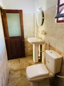 a bathroom with a toilet and a sink at Casalanka Hotel in Hikkaduwa