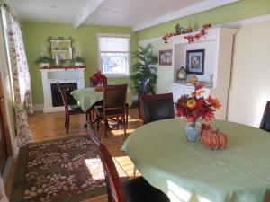 a dining room with a table with pumpkins on it at That Country Place B&B in Hanna