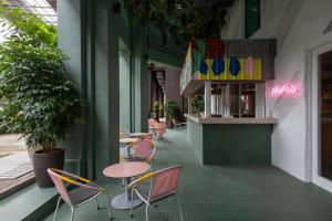 a restaurant with chairs and tables on the side of a building at MoMo's Kuala Lumpur in Kuala Lumpur