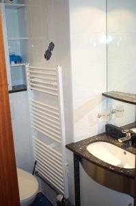 a bathroom with a sink and a toilet and a mirror at Ferienresidenz-79-5 in Staberdorf