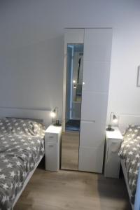 a bedroom with two beds and a mirror at Ferienresidenz-79-5 in Staberdorf
