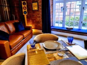 a living room with a couch and a table and chairs at Cocoa Isabella - River fronted with secure parking in York