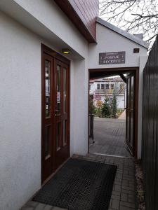 an entrance to a building with a sign on the door at Restaurant Penzion City in Jirkov