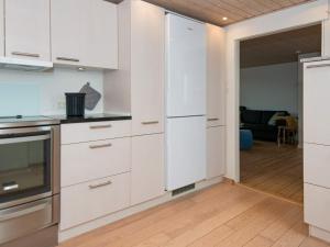 cocina con armarios blancos y puerta abierta en 4 person holiday home in Esbjerg V, en Esbjerg