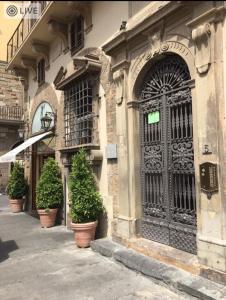 a building with a door and potted plants on a street at Caterina apartment in Florence