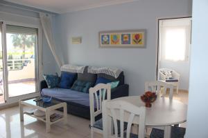 a living room with a blue couch and a table at Medina Molins - Deniasol in Denia
