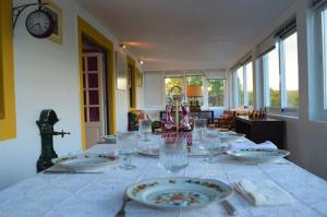 a table with plates and wine glasses on it at Quinta do Chaparrinho in Sardoal