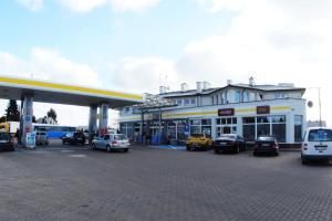 a gas station with cars parked in front of it at Motel WiG in Sandomierz