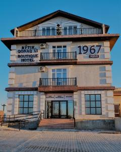 a building with a sign on the front of it at BOUTIQUE HOTEL 1967 AQSAI in Aksay