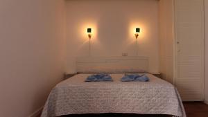 a bedroom with a bed with two blue towels on it at Marlenghi Apartments View Canteras in Las Palmas de Gran Canaria
