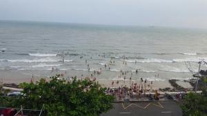 a group of people on a beach in the ocean at Homestay coco in Vung Tau