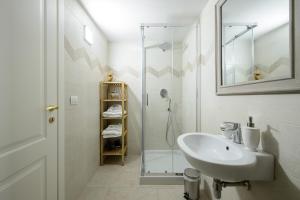a white bathroom with a sink and a shower at Milcovich Suites in Barletta +64 photos