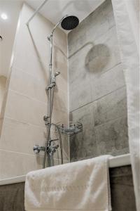 a shower with a glass door in a bathroom at BOUTIQUE HOTEL 1967 AQSAI in Aksay