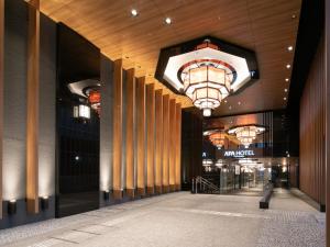a lobby of a building with a large chandelier at APA Hotel Kyoto-Eki Higashi in Kyoto