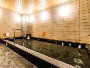 a swimming pool in a building with a pool at APA Hotel Kyoto Eki Higashi JR Kyoto Station 3 min on foot in Kyoto