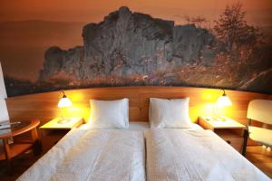 A bed or beds in a room at Geopark Vendégház