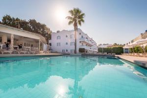 a large swimming pool in front of a building at Aegean Blu Kos in Kos