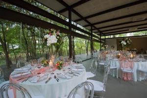 a banquet hall with white tables and chairs and flowers at Vivari Hotel and Spa by Mantis in Johannesburg