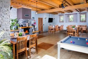 a dining room with a pool table and a bar at Alzbeta resort - Aqua & Wellness in Liptovský Mikuláš