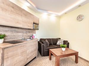 a living room with a couch and a table at VacationClub – Diva Apartament 522 in Kołobrzeg
